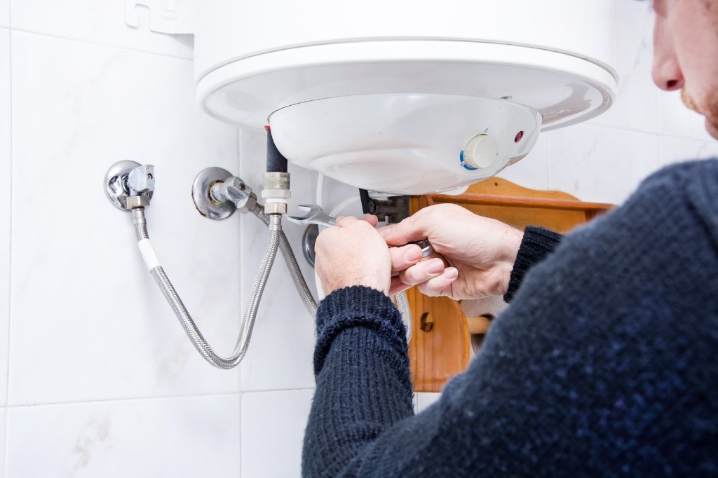 Plumber servicing a water heater